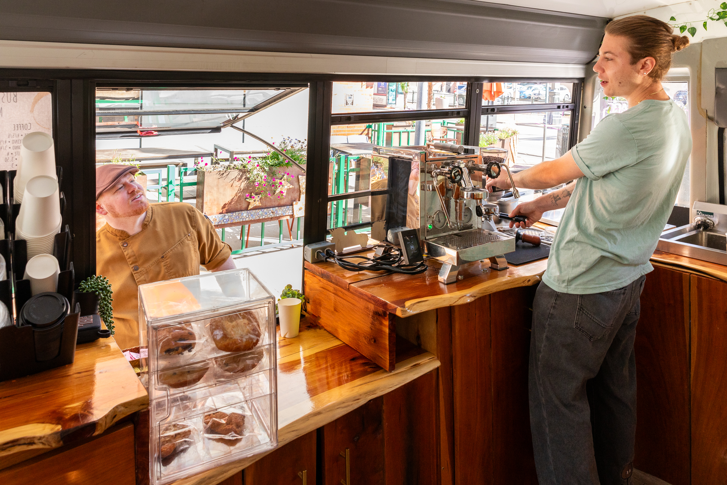 Busy downtown Denver street scene with Buspresso coffee truck
